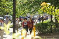 A candid photo of people walking on the CUIMC campus is shown.